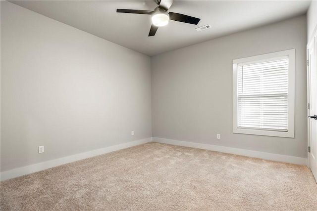 unfurnished room with a ceiling fan, carpet flooring, visible vents, and baseboards