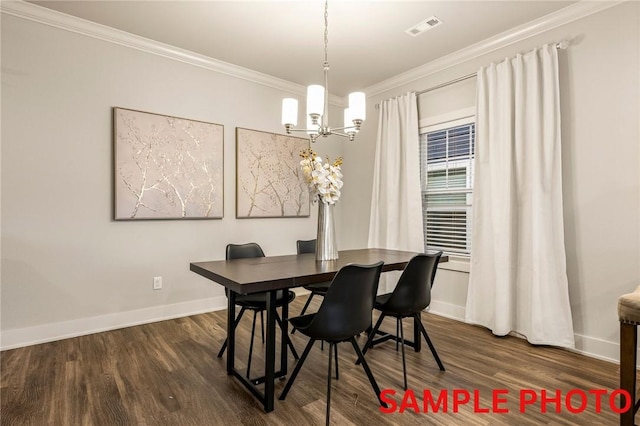 dining space with baseboards, wood finished floors, visible vents, and ornamental molding