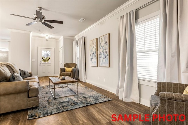 living room featuring ceiling fan, wood finished floors, baseboards, and ornamental molding