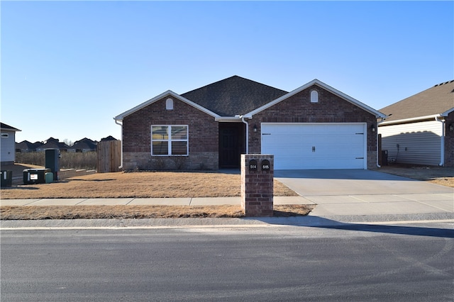 view of front facade with a garage, brick siding, and driveway