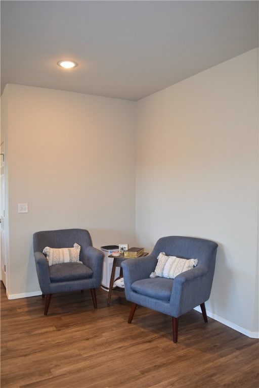 living area with baseboards, wood finished floors, and recessed lighting