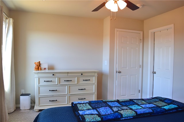 carpeted bedroom featuring a ceiling fan and baseboards