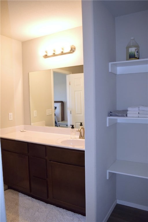 bathroom with vanity and baseboards