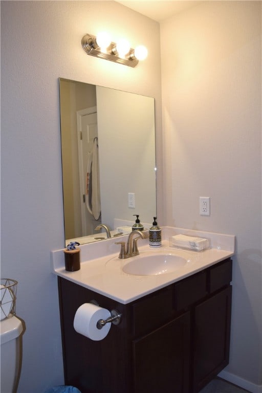 half bath with vanity and toilet