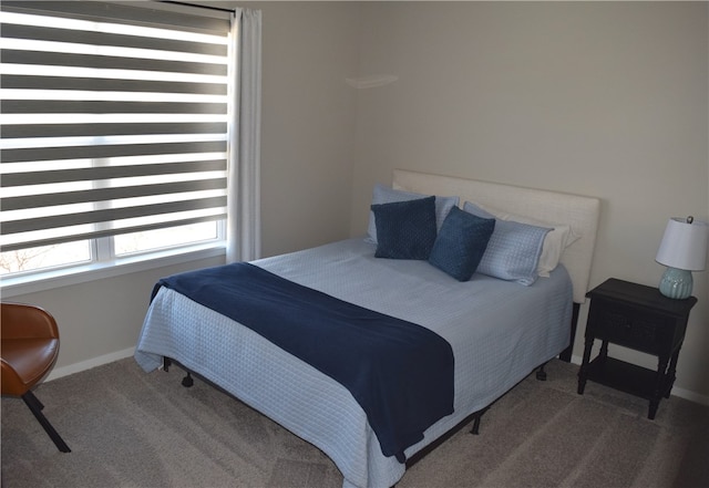 carpeted bedroom featuring baseboards