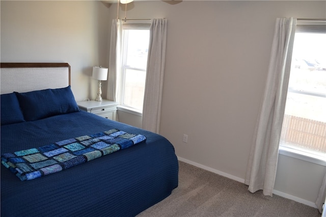 bedroom with light carpet and baseboards