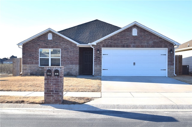 ranch-style home with driveway, a shingled roof, a garage, and brick siding