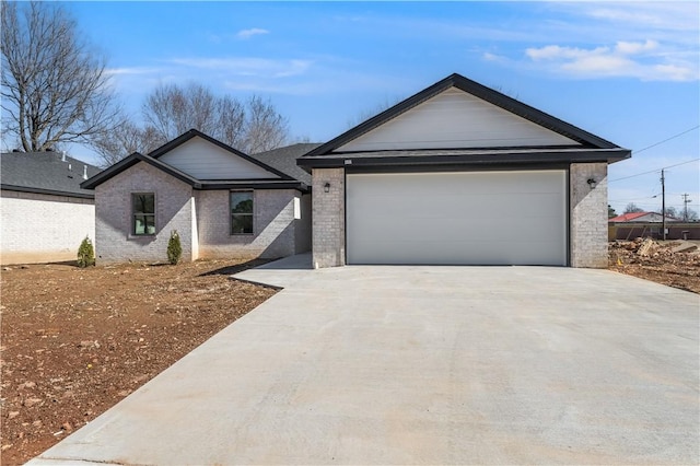 single story home featuring a garage, brick siding, and driveway