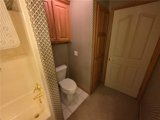 full bath with toilet, wallpapered walls, and tile patterned flooring