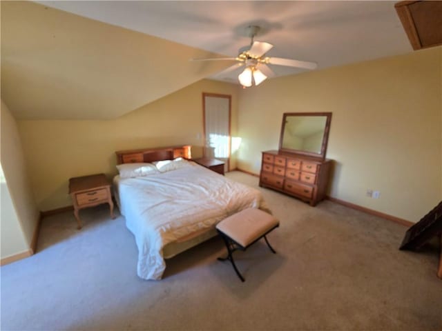 carpeted bedroom with vaulted ceiling, a ceiling fan, and baseboards