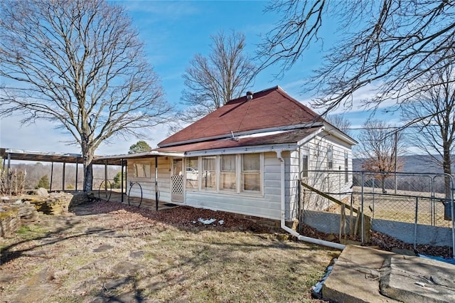 back of house featuring fence