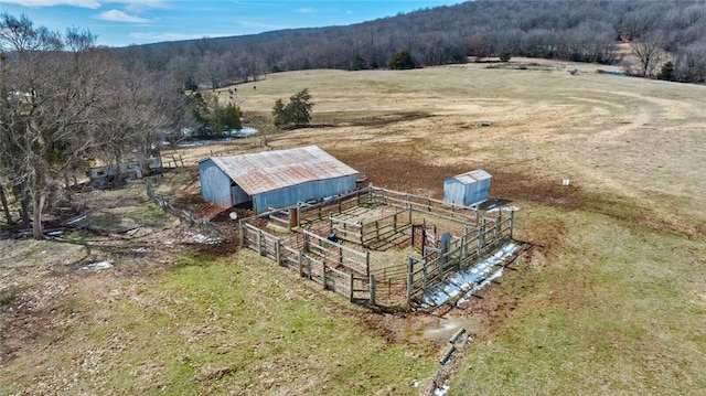 birds eye view of property featuring a rural view and a view of trees