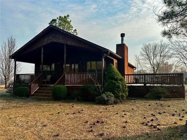 rear view of property with a chimney