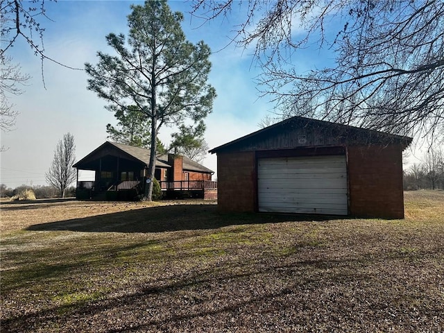 detached garage with dirt driveway