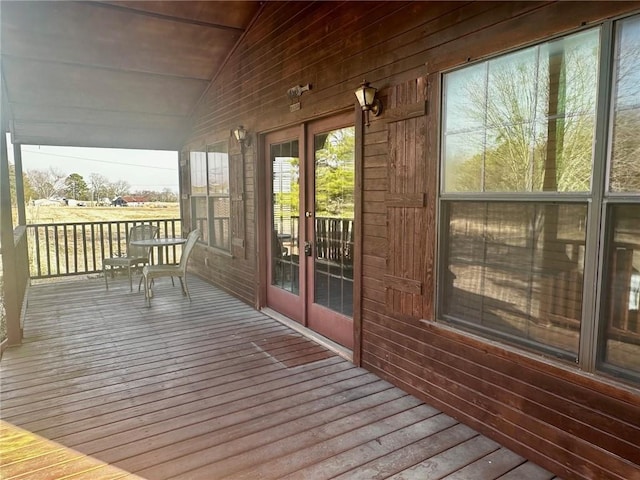 unfurnished sunroom featuring vaulted ceiling and french doors