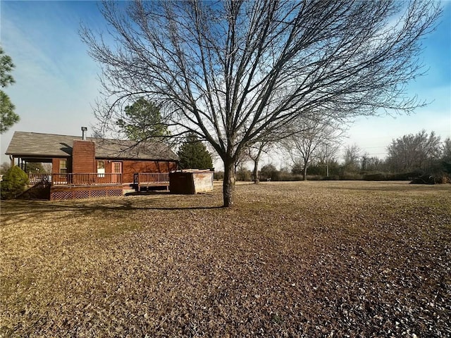 view of yard with a wooden deck