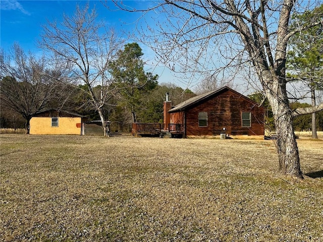 view of yard featuring an outbuilding and a wooden deck