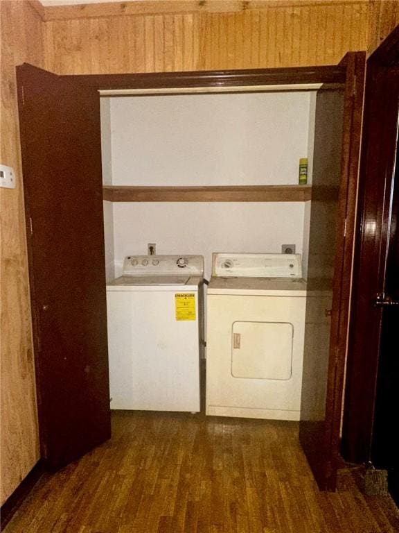 laundry area with wood finished floors, laundry area, and separate washer and dryer