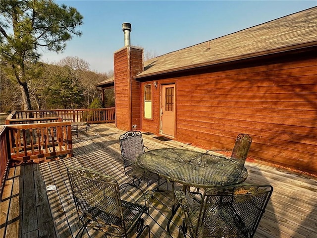 wooden terrace with outdoor dining area