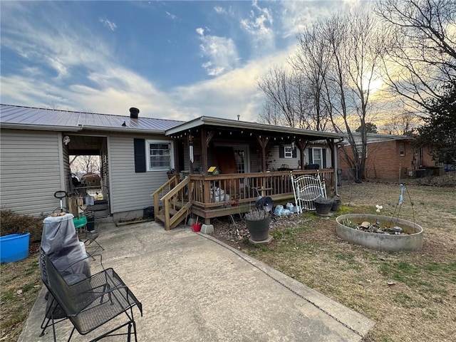 back of property featuring metal roof