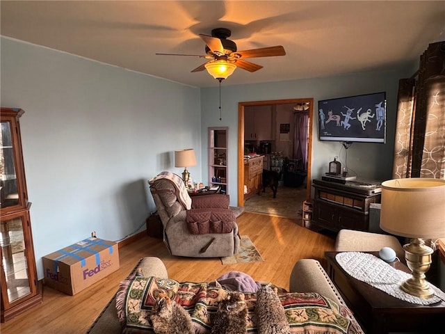 living room featuring ceiling fan and wood finished floors