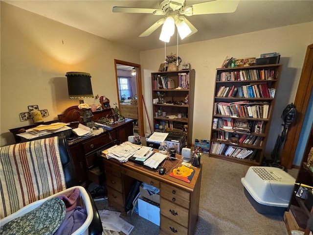 carpeted office featuring ceiling fan