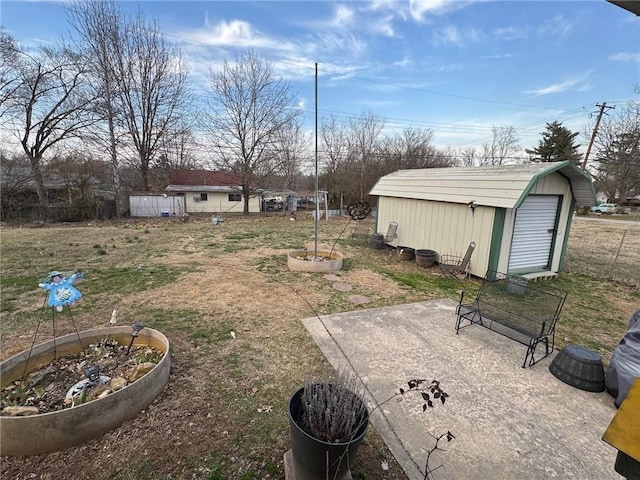 view of yard featuring a storage unit and an outbuilding