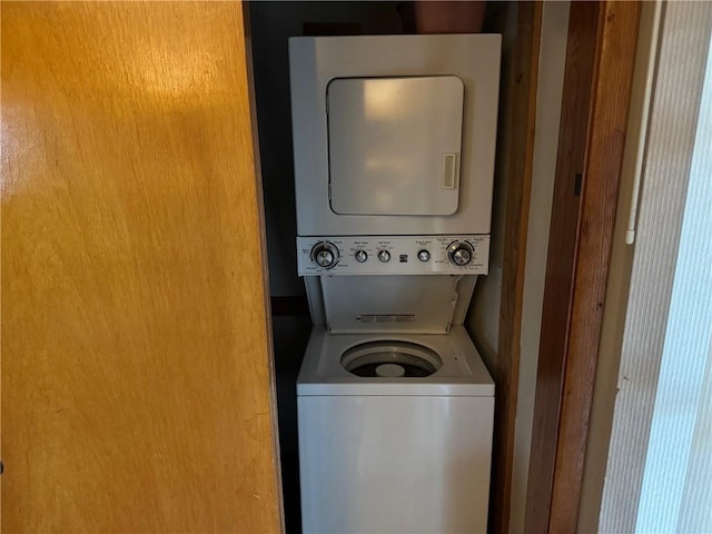 washroom with laundry area and stacked washing maching and dryer