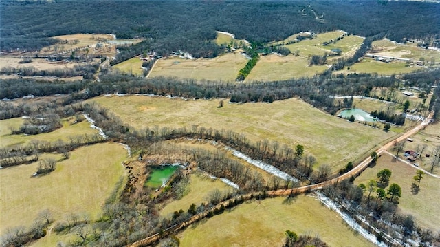 birds eye view of property with a rural view