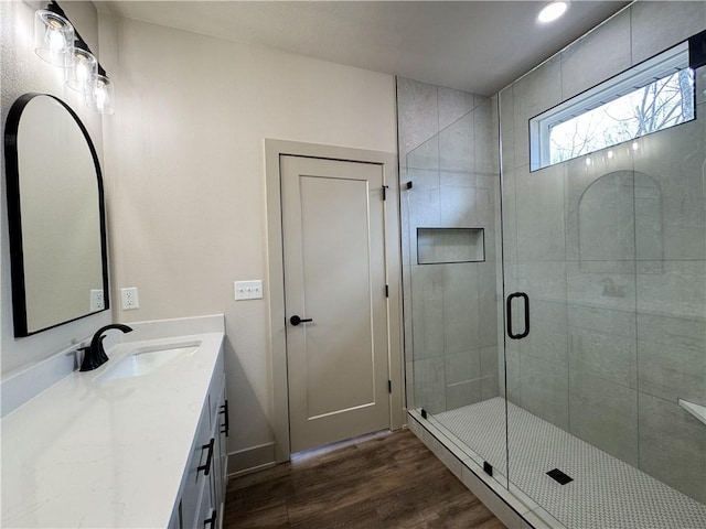 full bath featuring recessed lighting, wood finished floors, vanity, and a shower stall