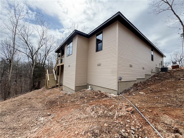 view of side of home featuring stairway