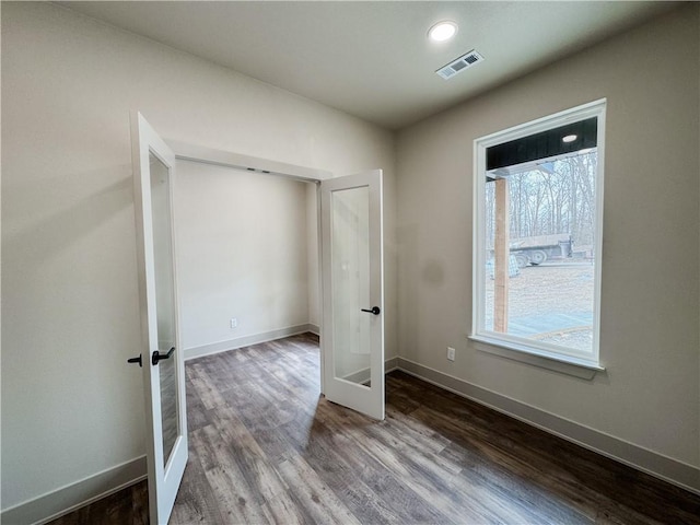 unfurnished bedroom featuring baseboards, visible vents, wood finished floors, french doors, and recessed lighting