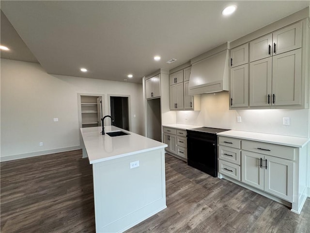 kitchen with electric range, custom range hood, a sink, and recessed lighting