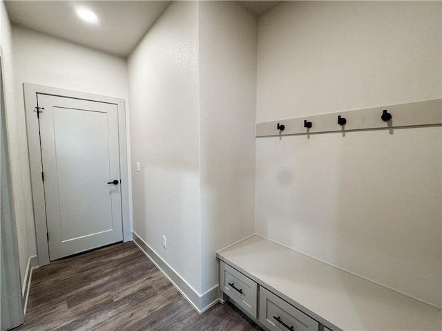 mudroom featuring dark wood-type flooring and baseboards