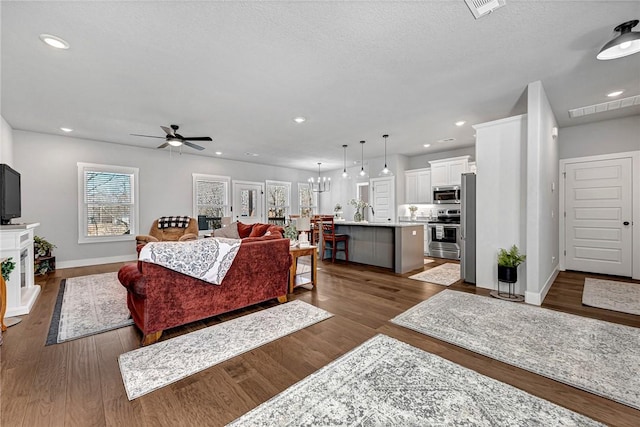 living area with visible vents, recessed lighting, baseboards, and dark wood-style flooring