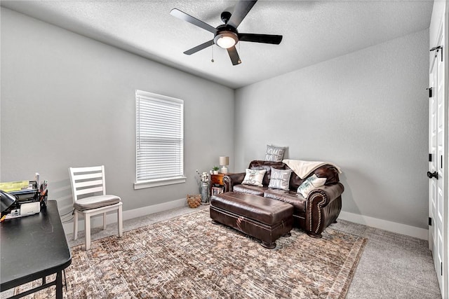 interior space featuring ceiling fan, a textured ceiling, baseboards, and carpet floors