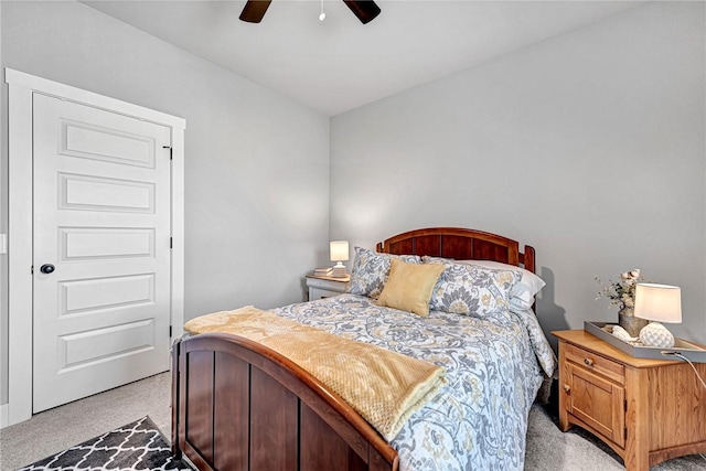 bedroom with light carpet and a ceiling fan