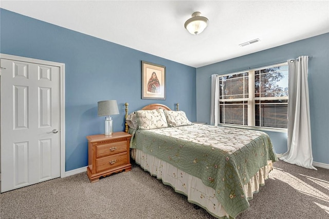 bedroom featuring light carpet, visible vents, and baseboards