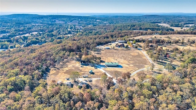 birds eye view of property with a view of trees