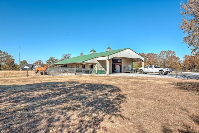 view of front of property with a carport, an outdoor structure, and an exterior structure