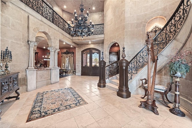2 S Samoset Ct, Rogers, AR 72758 - entryway featuring a high ceiling, a chandelier, decorative columns, french doors, and arched walkways