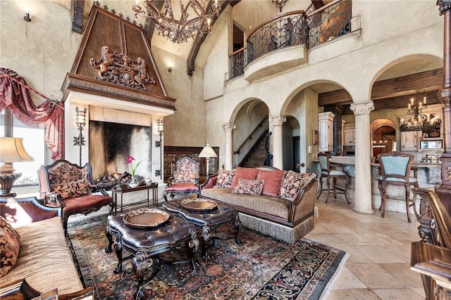 2 S Samoset Ct, Rogers, AR 72758 - living area with a high ceiling, arched walkways, stone tile floors, and ornate columns
