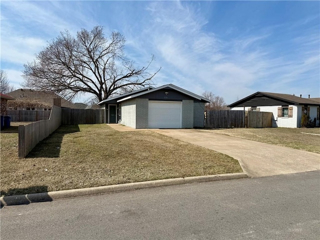 view of front facade featuring concrete driveway, brick siding, a front lawn, and fence