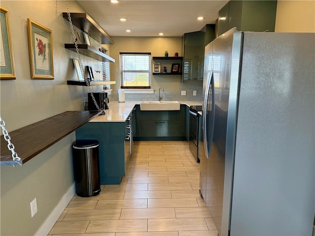 kitchen with electric range, a sink, backsplash, freestanding refrigerator, and open shelves