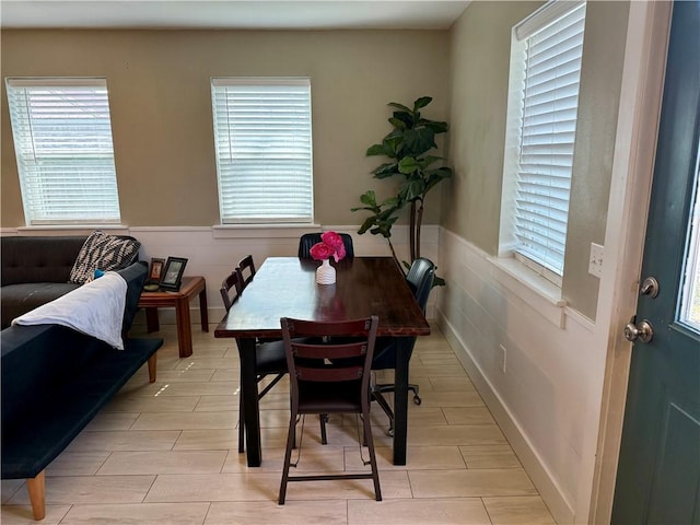 dining room with wood tiled floor and wainscoting