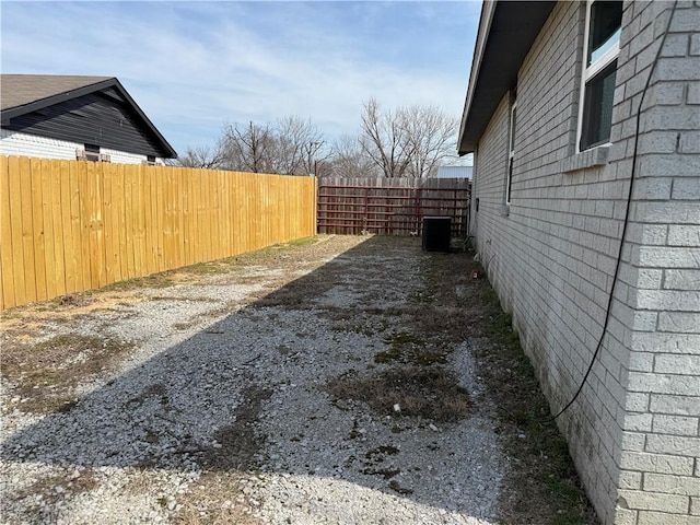 view of yard with cooling unit and fence