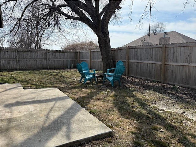 view of yard featuring a fire pit, a patio area, and a fenced backyard