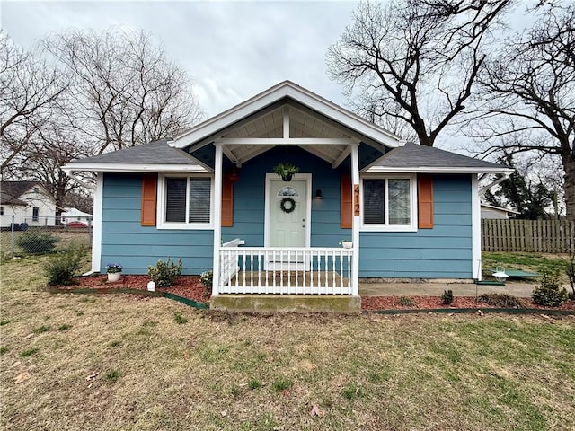 bungalow with a front yard and fence