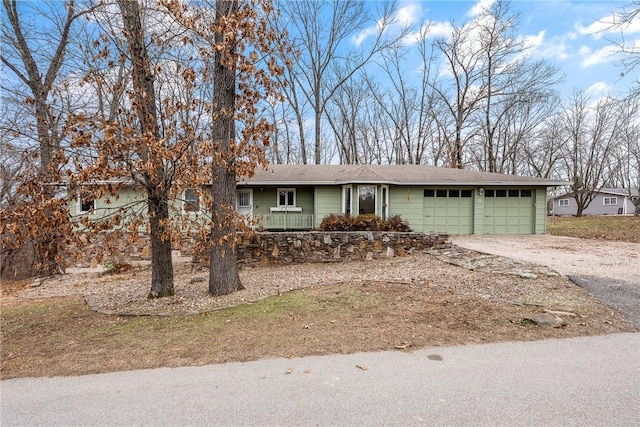 single story home with a garage and driveway