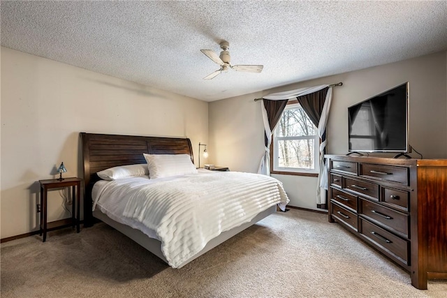 bedroom featuring light carpet, ceiling fan, and baseboards